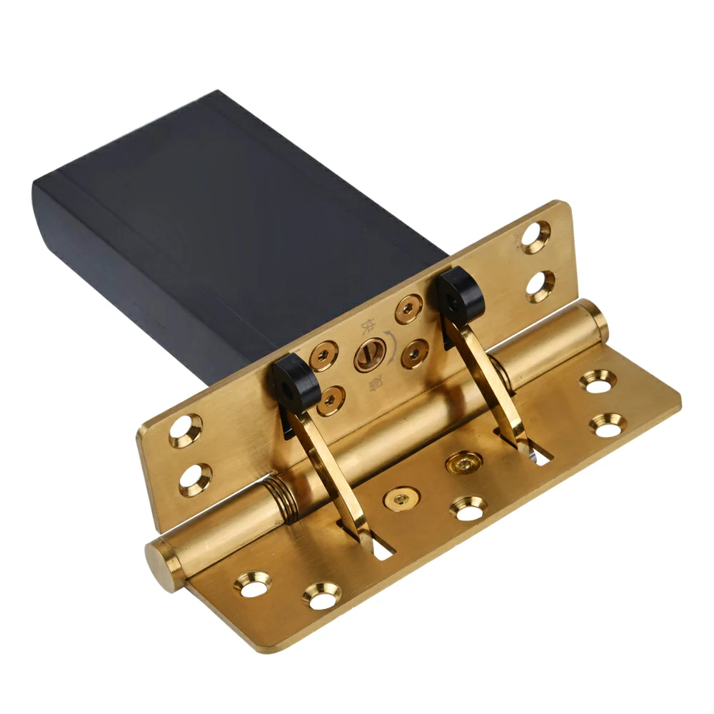 Close-up of the adjustable speed valves on a gold hydraulic door hinge.