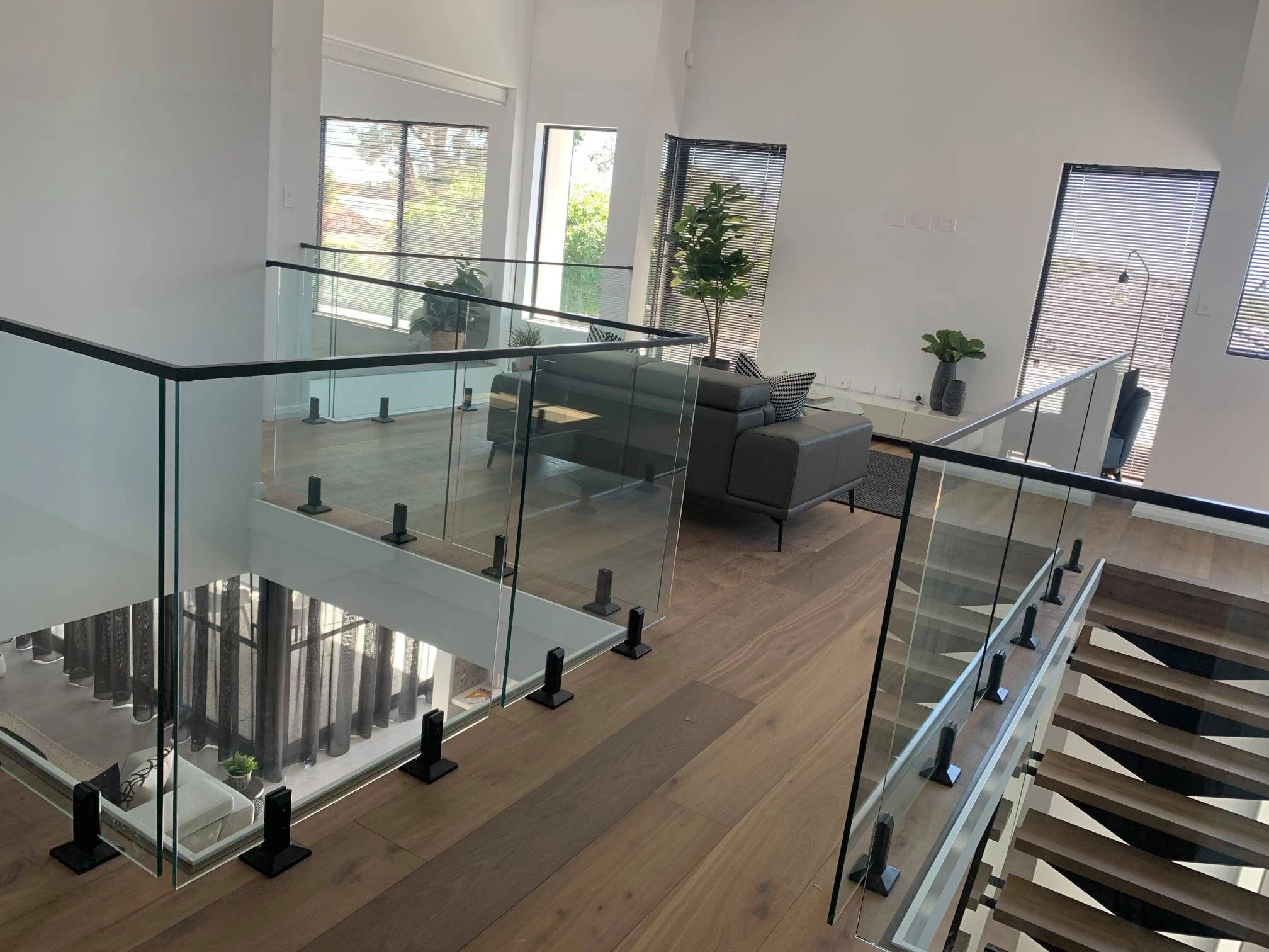 Glass stair railing with black glass spigots