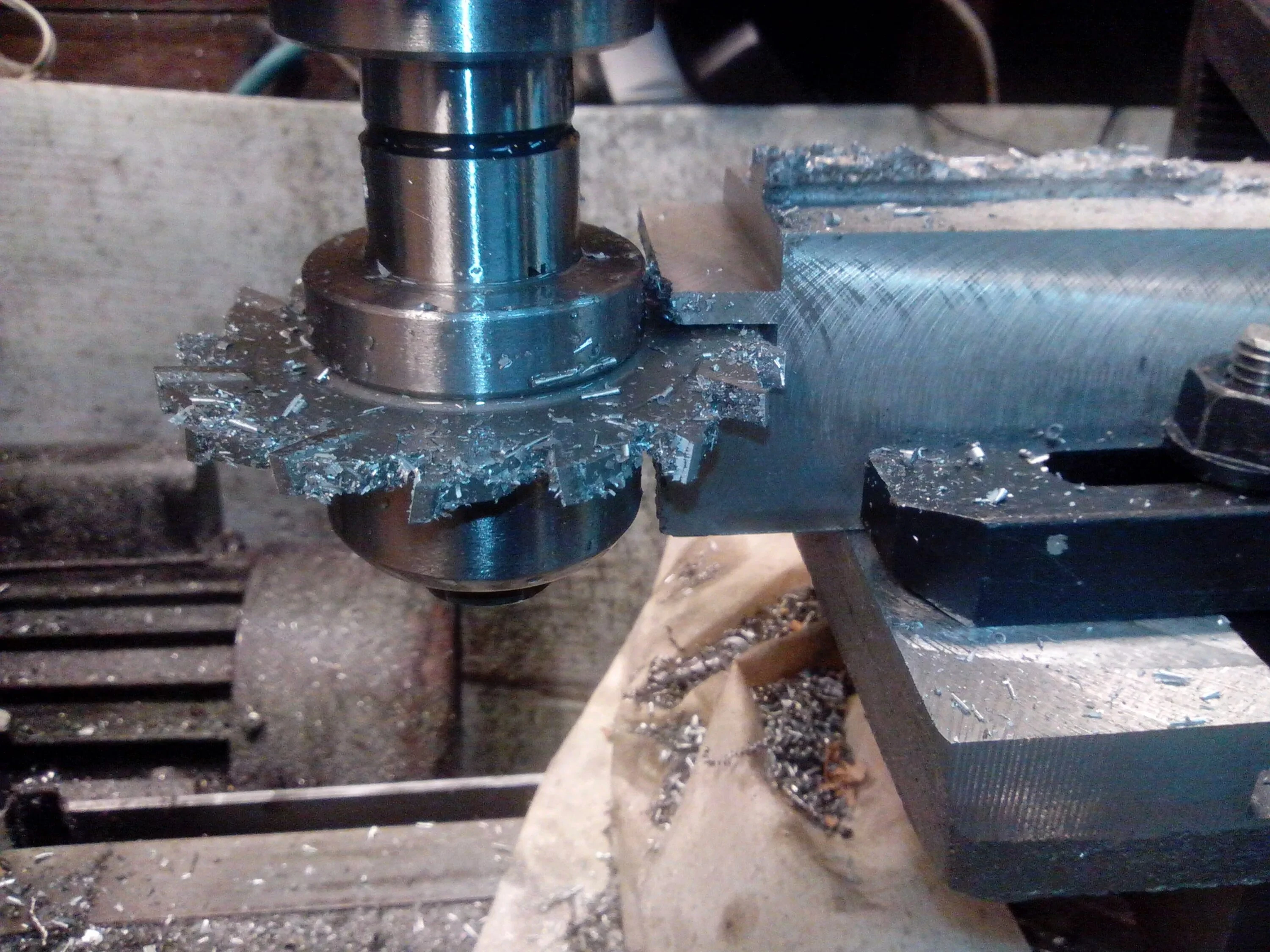 Milling machine cutting a metal casting with precision, focusing on dimensional accuracy and fine surface finish, with visible metal shavings.