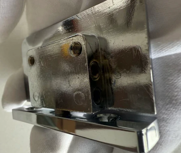 Solid brass shower hinge backplate with high-quality mirror finish, showing heavy-duty mounting structure.