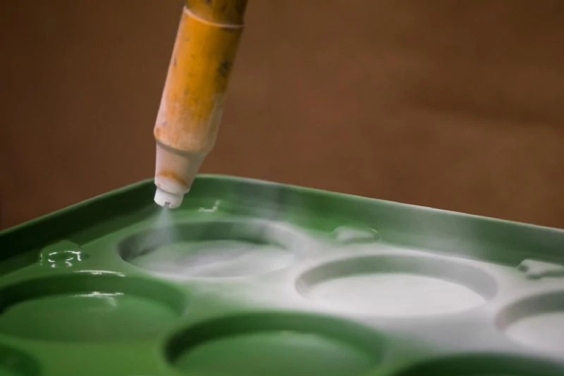 A clean, pre-treated aluminum surface with a matte finish, prepared for the coating application to ensure a strong bond between the substrate and paint.